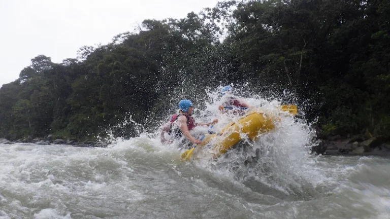 Tourists cheering after successfully crossing a massive class IV rapid on the Pastaza River