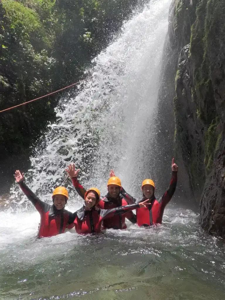 Adventurer performing a technical waterfall rappel during Cashaurco canyoning tour in Ecuador.