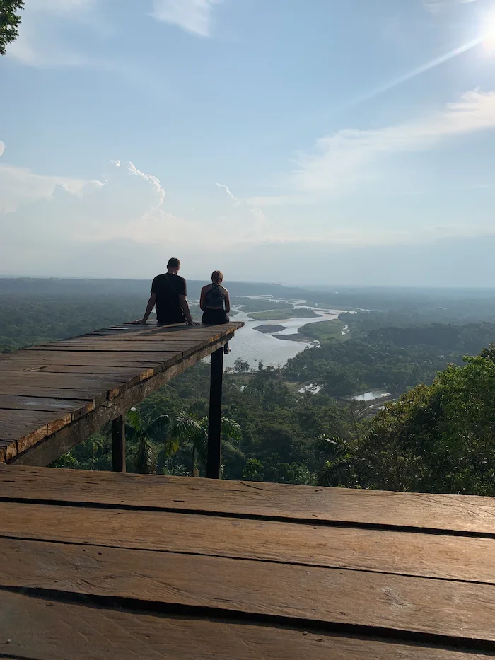 Panoramic viewpoint overlooking the vast Amazon rainforest canopy and river basin near Baños Ecuador.