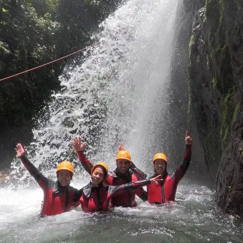 Adventurer performing a technical waterfall rappel during Cashaurco canyoning tour in Ecuador.