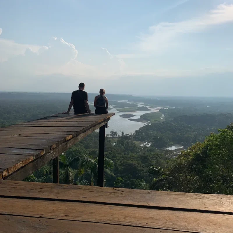 Panoramic viewpoint overlooking the vast Amazon rainforest canopy and river basin near Baños Ecuador.
