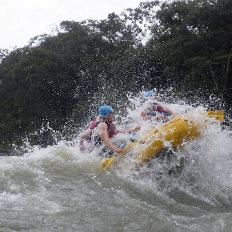 Tourists cheering after successfully crossing a massive class IV rapid on the Pastaza River